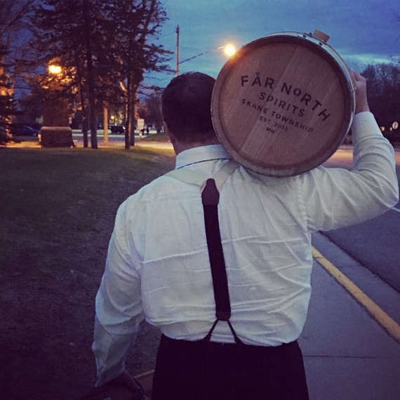 hombre carrying far north distillery barrel